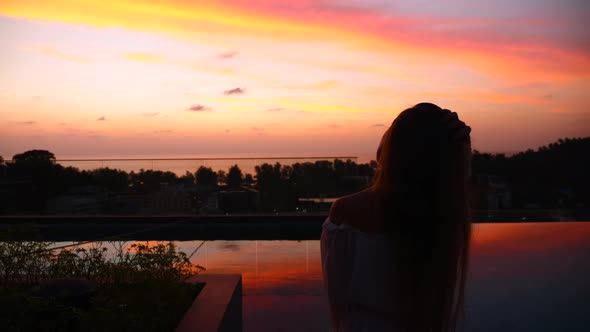 Silhouette of Travel Woman on Sunset with Bright Orange Color Light