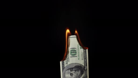 Burning of American Hundred Dollar Banknote on Black Background