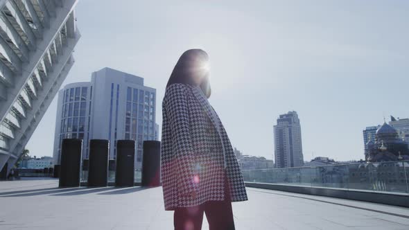 Pivoting Around a Young Asian Business Woman Walking in Downtown