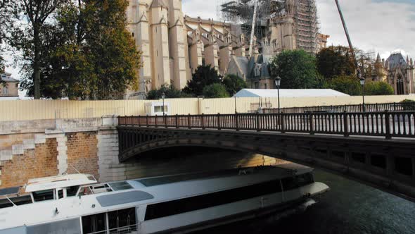 Paris, France - September 2019: Cruise Ship Goes Along the Seine Near Notre-Dame De Paris