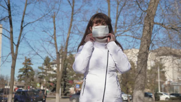 Healthy Girl Wearing Protective Medical Mask On Street, Showing Like. Free Woman Wears a Medical