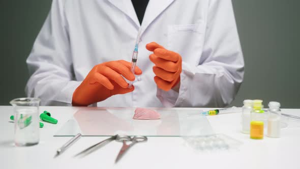 Medical Scientist Specialist Wearing Orange Gloves Injecting Meat with Syringe Food Research in