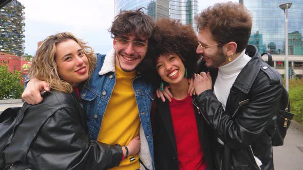 Group of diverse multithnic friends outdoors having fun hugging