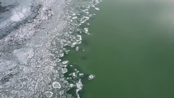 Flying over lake viewing ice and water texture separation