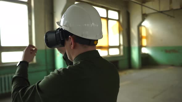 An Engineer Wearing Virtual Reality Glasses Moves Digital Objects with His Hands