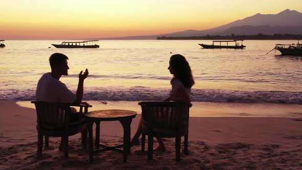 Young Man and Woman on Honeymoon Vacation Enjoy Luxury on Beach on Sunny White Sandy Background