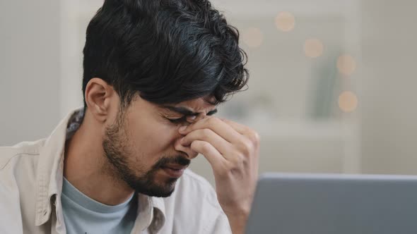 Closeup Male Focused Arabic Young Guy Business Man Freelancer Looking at Laptop Tired Discomfort in