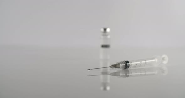 Syringe And Vaccine On White