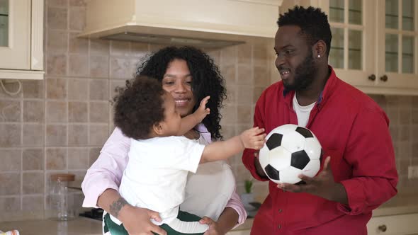 Handsome Smiling African American Father Husband Playing with Soccer Ball in Slow Motion Talking