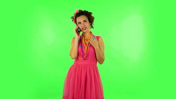 Portrait of Smiling Girl Talking for Mobile Phone and Rejoice. Green Screen