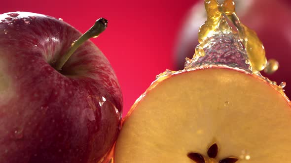 Slow Motion Shot of Red Apple Juice Splashing Through Apple Slices