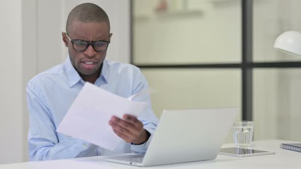 Angry African Man Upset After Reading Documents Work