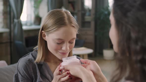 Young Woman Smelling Strawberry Body Butter