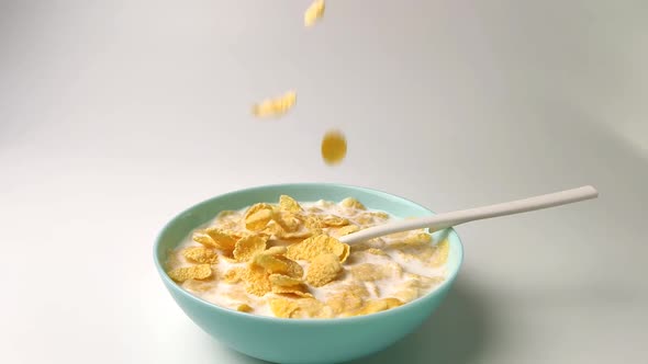 Stir Cornflakes with Milk, Healthy Breakfast, Slow-motion Shooting on a White Background.