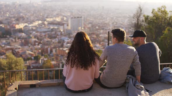 Three friends looking at the city of Barcelona, Spain