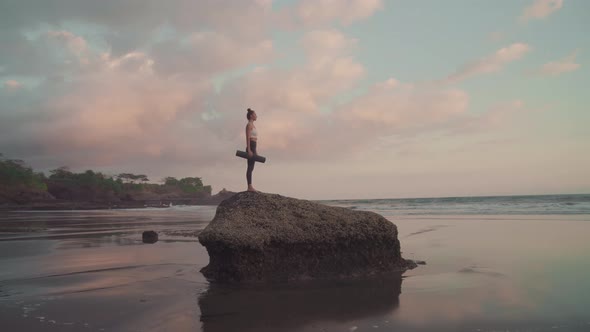 Girl Standing on Stone at Sunset