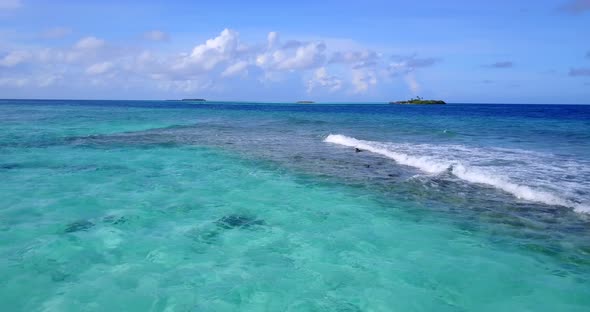 Luxury above copy space shot of a summer white paradise sand beach and blue water background in 4K