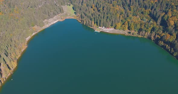 Aerial View Of St. Ana's Crater Lake In Romania During Autumn - drone shot