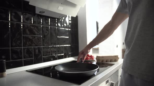 Kitchen. Man Pouring Oil On Frying Pan For Cooking  Breakfast