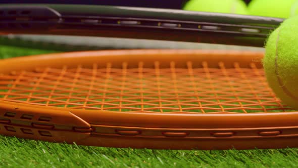Two Tennis Rackets Lying on Grass Background Close Up