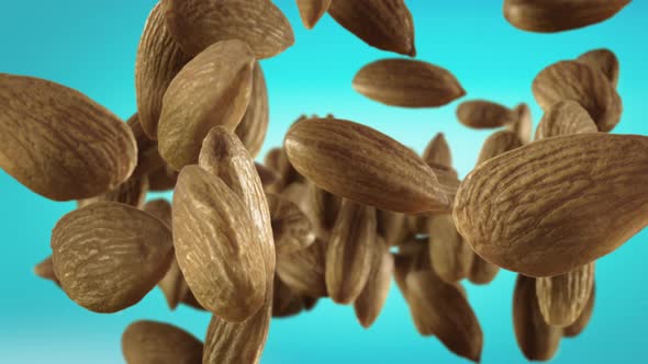 Flying of Almonds in Ice Blue Background