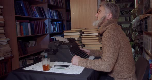 Ernest Hemingway is sitting at the desk and writing with a typewriter, 4k