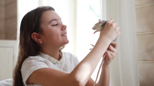 Little Girl Playing With a Pet Rat