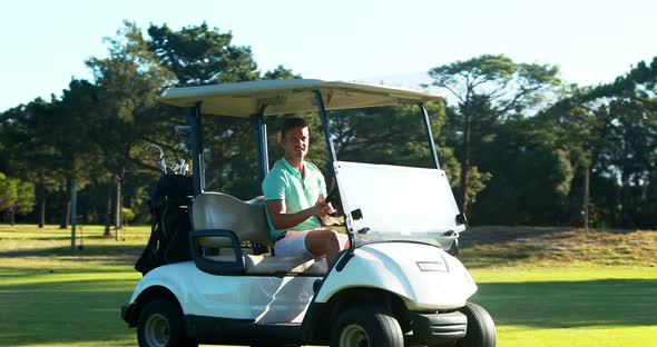 Golfer driving in his golf buggy