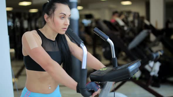 Girl Working on a Stationary Bike at the Gym,beautiful Woman at the Gym