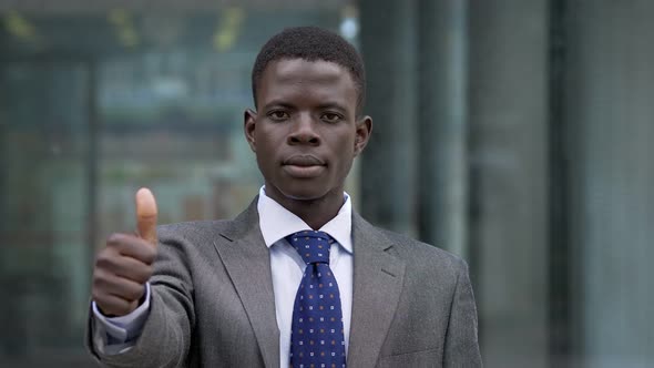 Young African American businessman making thumb up. Positivity,optimism -outdoor