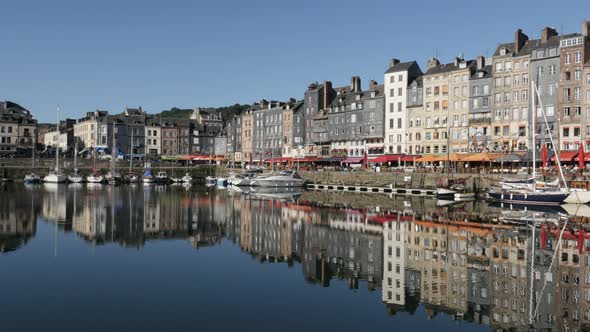 HONFLEUR, FRANCE - SEPTEMBER 2016  Colorful facades water reflection of famous northern Normandy art