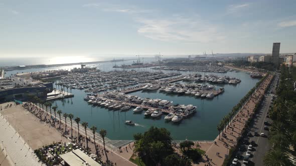 Orbiting over Alicante Recreation Harbor, Sailing boats moored at the Marina, Spain