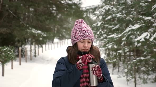 Young Woman Walking in the Winter Park