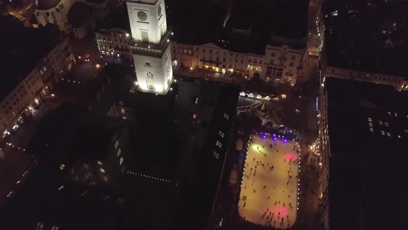 Arial View of City Lviv Ukraine Rynok Square Christmas Fair People Skate on Ice Skating Rink