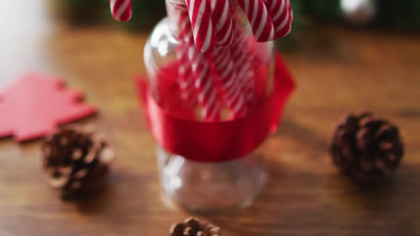 Video of christmas decorations with pine cones and candy canes at home