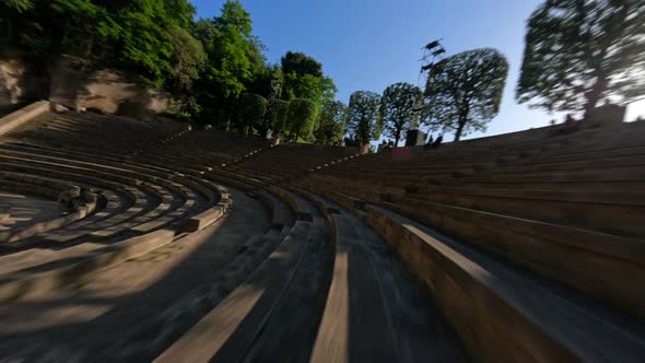 Dynamic Fpv Drone Shot Cruising Around Ancient Amphitheater Sunny Day