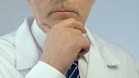 Professional Doctor Pondering Over Diagnosis, Medical Research, Face Close Up