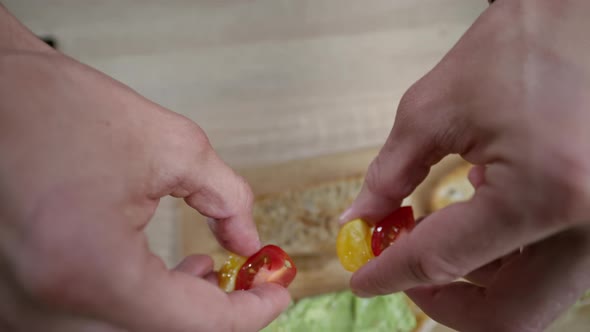 Slow Motion Video of a Hand Putting Cherry Tomatoes