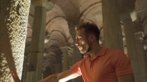 The man who put his hand on the column in the historical place.