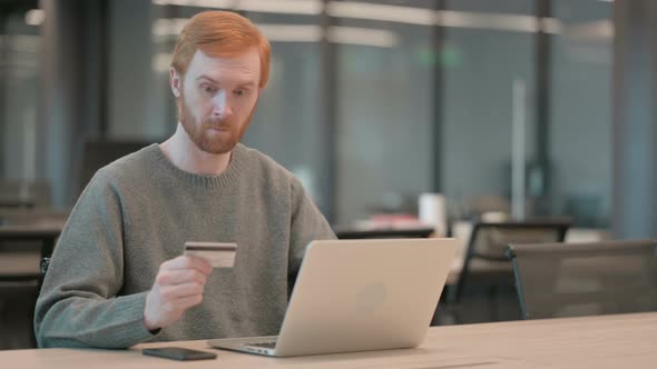 Young Man Making Successful Online Payment on Laptop