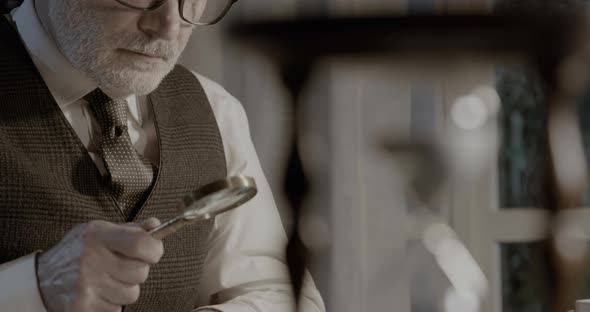 Professor working in his office and hourglass