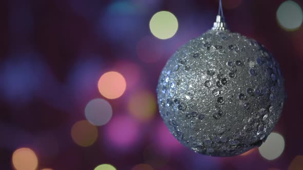 Christmas ball toy on bokeh background of flashing lights