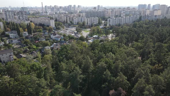 Megalopolis Next To the Forest: the Contact Between the Big City and Nature. Aerial View. Slow