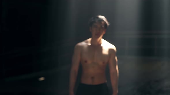 4K Portrait of Asian man bodybuilder do sport training workout exercise in abandoned building.