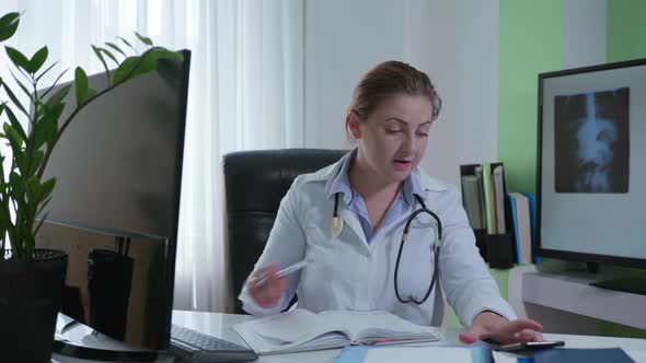 Online Doctor, Female Professional Hospital Employee Communicates with Patient on Smartphone