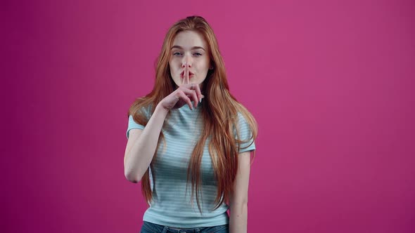 Slow Motion Redhead Girl Who Puts Her Index Finger to Her Lips Keeps the Secret Locks Her Mouth with