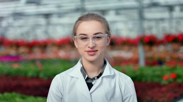 Medium Closeup Portrait of Beautiful Smiling Female Agricultural Engineer in Uniform