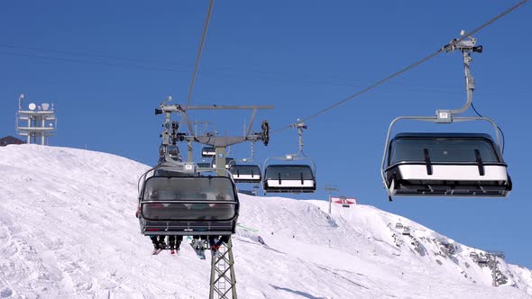 Ski Lift Moving Over Snowy Landscape in Austrian Alps