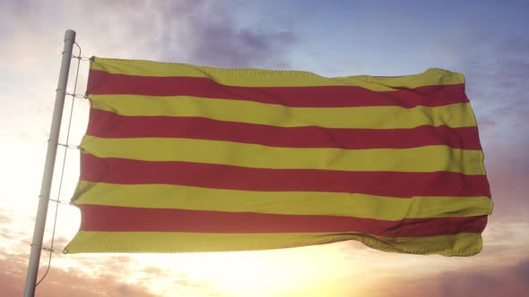 Catalonia Flag Spain Waving in the Wind Sky and Sun Background