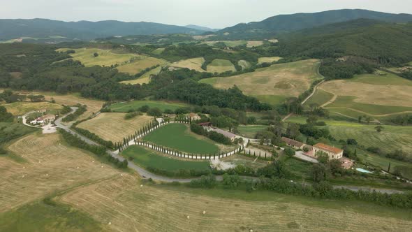 Aerial images of Tuscany in Italy cultivated fields summer, I fly forward over a heart-shaped farm